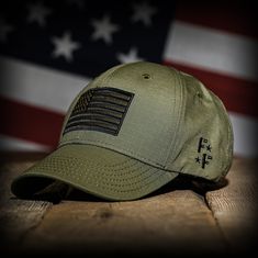 RANGER GREEN RIPSTOP FULL FABRIC AMERICAN FLAG HAT 🇺🇸 MADE IN AMERICA With its subtle tone-on-tone Americana style, our ranger green ripstop flag hat is the perfect way to show your patriotism and love of country. We sourced USA-made ranger green ripstop for the front and back panels and embroidered a coordinating green and black flag on the front with our logo over the left side. We partner with a multi-generational family-owned American business to design, test, and build our hats right here Military Style Snapback Hat For Outdoor, Adjustable Military Style Snapback Hat, Military Style Adjustable Snapback Hat For Outdoor, Military-style Cotton Snapback Hat, American Flag Hat, Adjustable Camouflage Military Snapback Hat, Flag Hat, Ear Protection, Black Flag