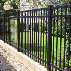 a black metal fence in front of a house