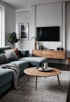 a living room filled with furniture and a flat screen tv mounted to the side of a wall