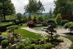 a garden with rocks, grass and trees in the middle is shown from high above