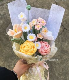 a person holding a bouquet of flowers in their hand