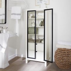 a bathroom with white walls and wooden floors