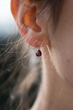 Exquisitely dainty 14k gold-filled earring studs with a rhodolite garnet briolette drop - little love drops for the ears. Elevate your elegance with our delicately handcrafted garnet drop earrings. A 14k gold-filled stud hosts a petite rhodolite garnet faceted briolette that gracefully catches light and moves as you do, adding an exquisite touch. These earrings are more than accessories; they're memories. Perfect for bridesmaids, they symbolize cherished moments. For mom, they express gratitude. For a girlfriend, they speak of affection. And for a wife, they echo love. Crafted to be a simple yet remarkable everyday accessory, these earrings effortlessly transform any look into something delicate and special. Whether as a personal indulgence or a thoughtful gift, these earrings offer a touc Luxury Briolette Pearl Earrings Elegant, Garnet Drop Earrings, Drop Earrings Gold, Express Gratitude, Tiny Earrings, Red Gemstones, Garnet Earrings, Earring Studs, Rhodolite Garnet