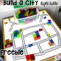 a table that has some legos on it and the words build a city in front of it