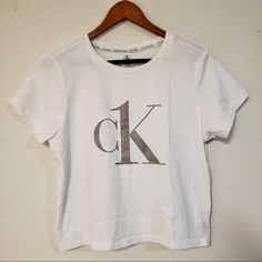 Size L. Never Worn Calvin Klein White Logo Print T-shirt, Calvin Klein Cotton Tops For Loungewear, Calvin Klein Crew Neck Tops For Loungewear, Calvin Klein Cotton Loungewear Tops, Calvin Klein Summer Loungewear Tops, White Calvin Klein Crew Neck T-shirt, Calvin Klein White Crew Neck T-shirt, White Calvin Klein Cotton T-shirt, Calvin Klein White Short Sleeve Top