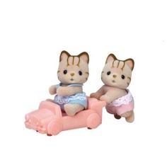 two small toy cats sitting on top of a pink car with one cat wearing a diaper