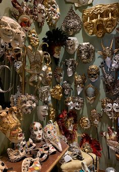 there are many masks hanging on the wall