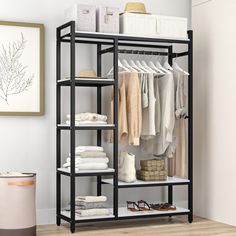 a black shelving unit with clothes on it