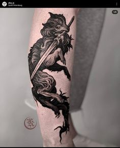 a black and white photo of a man's leg with a dragon on it