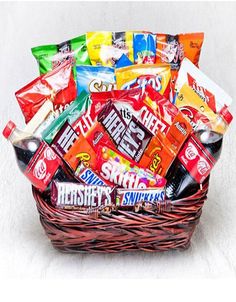 a wicker basket filled with assorted candy bars