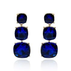 Add a touch of elegance to any outfit with these exquisite Sapphire triple cushion cut crystal earrings. Featuring a trio of brilliantly cut crystals, these earrings are designed to shine whether you’re pairing them with a casual white t-shirt or elevating your look for a gala affair. Their timeless design and ease of wear make them a versatile accessory, perfect for effortlessly enhancing your wardrobe with a hint of sophistication. Avoid contact with water and cosmetics, such as creams or perfumes. Clean with a clean dry cloth. Comes with a velvet pouch. Elegant Sapphire Earrings With Polished Finish, Elegant Sapphire Crystal Earrings, Luxury Blue Gold-plated Earrings, Luxury Polished Sapphire Earrings, Luxury Multi-stone Blue Topaz Earrings, Long Pendant, August Birthstone Jewelry, July Birthstone Jewelry, Men's Jewelry Rings