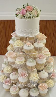 a wedding cake made out of cupcakes with flowers on the top and bottom