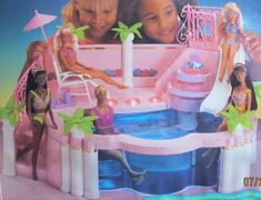 two girls playing in a barbie doll pool with toys and accessories on the table next to it