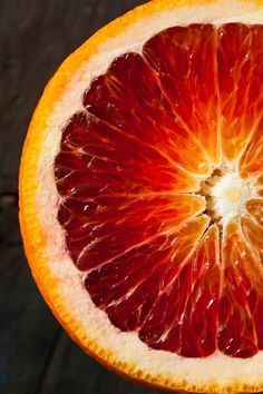 an orange cut in half sitting on top of a table