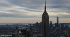 an aerial view of the empire state building in new york city, ny at sunset