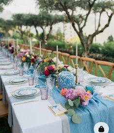 a long table is set with blue and white plates