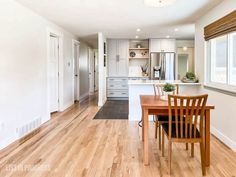 an empty kitchen and dining room with hardwood floors