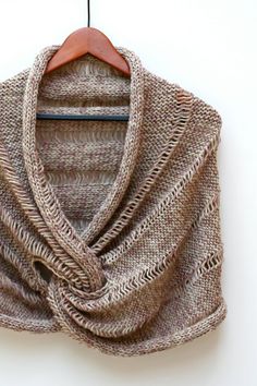 a brown shawl hanging on a white wall