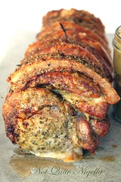 bacon wrapped in bread next to a jar of mustard