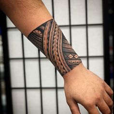 a man's arm with a tattoo on it that has an intricate design in the middle