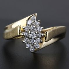 We Have For Sale This 14k Vintage Diamond Cluster Ring. This Ring Has 15 Round Diamonds For A Total Of .42 Carats In Diamonds. It Also Has Brushed Sides And It Is Stamped "Exquisite" Size: 6.75 Weight: 2.11 Dwt/3.28 Grams Metal: 14k Yellow Gold Stones: 15 Round Diamonds For .42ctw I-2740 Lo*Scx* G-279 Yellow Gold Diamond Cluster Ring For Anniversary, Yellow Gold Cluster Diamond Ring For Anniversary, Anniversary Yellow Gold Cluster Diamond Ring, Yellow Gold Cluster Jewelry With Brilliant Cut, Classic Yellow Gold Cluster Diamond Ring, Fine Jewelry Yellow Gold Cluster Diamond Ring, Marquise Cluster Ring In Stamped 14k Yellow Gold, Yellow Gold 14k Stamped Marquise Cluster Ring, Yellow Gold Marquise Cluster Ring Stamped 14k