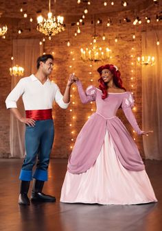 a man and woman dressed as disney characters