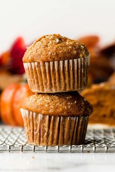 two muffins stacked on top of each other with strawberries in the background