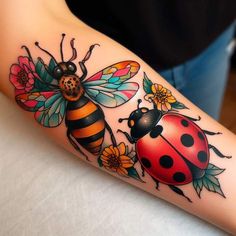 a ladybug and bee tattoo on the arm