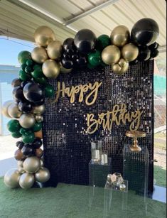 a black and gold birthday party with balloons