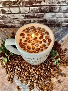 a cup filled with coffee beans sitting on top of a pile of roasted coffee beans