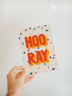 hand holding an off-white greeting card that says hooray with a colorful confetti background Trending Greeting Cards, Graphic Birthday Card, Birthday Card Graphic Design, Birthday Postcard Design, Birthday Card Design Ideas, Party Card Design, Congratulations Card Design, Christmas Card Design Ideas