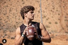 a young man holding a football in his hands