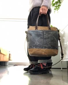 Tote bag in American heavy weight waxed canvas. The color is sage for the body, the magazine pocket that runs over the bottom for extra durability is made in heavy weight waxed canvas in also in sage, with a double outside pocket on the other side in medium weight black waxed canvas in grey. I made it into an everyday bag perfect for the office, with leather handles, shoulder strap, and 3 outside pockets Closing with a zipper on top. Including a leather shoulder strap, adjustable and detachable. Canvas Bags With Top Carry Handle For Outdoor, Outdoor Canvas Bag With Top Carry Handle, Canvas Bucket Satchel For Daily Use, Daily Use Canvas Bucket Satchel, Vintage Laptop Bag With Large Capacity For Everyday Use, Brown Canvas Bag With Top Carry Handle, Vintage Waxed Canvas Shoulder Bag For Everyday Use, Canvas Bucket Satchel With Adjustable Strap, Daily Coated Canvas Bag With Adjustable Strap