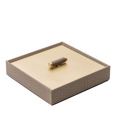 a brown and white box with a handle on it's side, sitting on a white surface