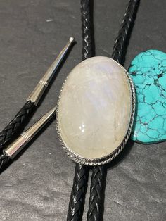 *Moonstone Bolo tie with silver tips *Sterling Silver *Free Shipping *Handcrafted In USA *Jewelry ship in Gift box * Ready to ship * Rainbow Moonstone Cabochons bolo Thank You For Your Looking ,And Check Out More Items In My Etsy Shop For More Great Deals, Also We Add More Jewelry To Etsy Shop regularly PLEASE check their dimensions, before setting the order. NOTE -Once the parcel gets shipped out, it is usually needed 3-6 business days for every where in US Please keep in mind that once your pa Adjustable Moonstone Jewelry With Round Stone, Adjustable Sterling Silver Jewelry With Large Stone, White Moonstone Classic Jewelry, Classic White Moonstone Jewelry, Artisan White Stone Jewelry, Classic Adjustable Jewelry With Large Stone, Adjustable White Gemstone Jewelry, Classic Adjustable White Moonstone Ring, Adjustable White Artisan Jewelry