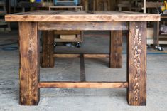 a wooden table sitting inside of a garage