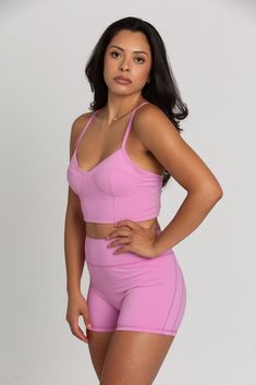 Our Light Magenta Sports Bra Top is such a stunner. Double lined for maximum coverage with removable padding for extra support. The bustier design is ultra-trendy, making this the perfect sports bra for your hardest workout class. Athleisure Sports Bra With Built-in Padding And Wide Straps, Compressive Crop Top With Built-in Padding For Workout, Fitted Activewear With Built-in Padding And Tank Straps, Sporty High Stretch Crop Top With Built-in Padding, Sporty Fitted Bra With Built-in Support, Fitted Sports Bra With Built-in Bra For Gym, Fitted Training Bra With Removable Pads, Athleisure Crop Top With Adjustable Straps For Sports, Sporty Crop Top With Adjustable Straps And Medium Support