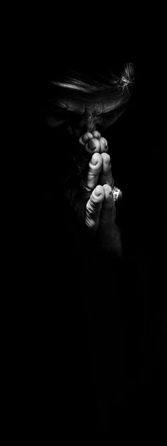 black and white photograph of a woman holding her hands to her face with both hands