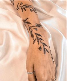 a woman's hand with a tattoo on it and the word love written in cursive writing