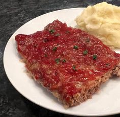 meatloaf and mashed potatoes on a white plate