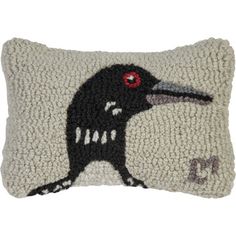 a pillow with a black bird on it