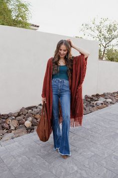 Women's Oversized Frayed Cardigan Open Bohemian Ruana Wrap yourself in playful bohemian vibes with our Open Bohemian Ruana. The oversized fit and frayed fringe detail add a touch of quirkiness to any outfit. Plus, it's one size fits all for easy and cute styling. Perfect for those who don't take fashion too seriously. (Wink!) Details Available in size: One size Available in colors: Navy, Rust, and Brown Long sleeves Open front Frayed fringe detail Open knit detail Oversized Sizing One size fits Hippie Style Outerwear For Fall Beach Events, Hippie Style Outerwear For Beach In Fall, Bohemian Long Sleeve Outerwear With Frayed Hem, Hippie Style Fall Beach Outerwear, Bohemian One Size Outerwear With Tassels, Casual Spring Poncho With Tassels, One Size Bohemian Outerwear With Tassels, Casual Cotton Outerwear With Tassels, Bohemian Outerwear With Frayed Hem For Festivals