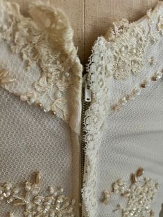 the back of a wedding dress with beading on it