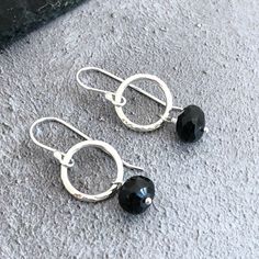 Perfect as a gift to a loved one or a treat for yourself. Great to go with that little black dress! Black spinel is a stunning gemstone which is acknowledged in the gemstone industry to be as lustrous as black diamond!  Alternative August birthstone - a modern & elegant drop earring created with handmade, textured sterling silver rings and faceted rondelles of black spinel gemstones hanging from handmade sterling silver, shepherd hook ear wires.  Spinel, which comes in a stunning range colours a Minimalist Black Sterling Silver Earrings, Modern Black Sterling Silver Earrings, Everyday Black Sterling Silver Earrings, Modern Black Earrings For Anniversary, Nickel-free Black Earrings For Party, Black Nickel-free Earrings For Party, Black Hypoallergenic Earrings For Anniversary, Black Hypoallergenic Jewelry For Party, Nickel Free Black Earrings For Anniversary