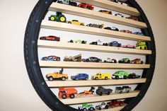 there are many toy trucks on the shelves