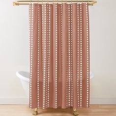 an orange shower curtain with white dots on it