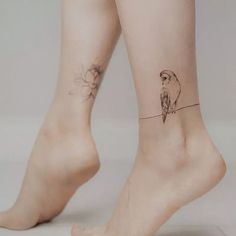 a woman's legs with two small tattoos on her ankles and one has a bird sitting on top of the leg