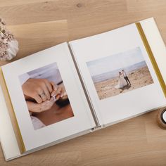 an open photo book with two pictures on the pages and a candle next to it