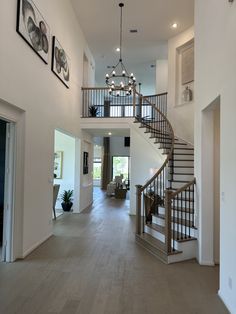 a large open floor plan with stairs leading up to the second story