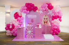 there is a barbie birthday party with balloons and decorations